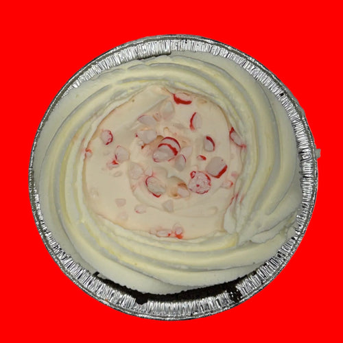 Small pie in a foil tin on a red background