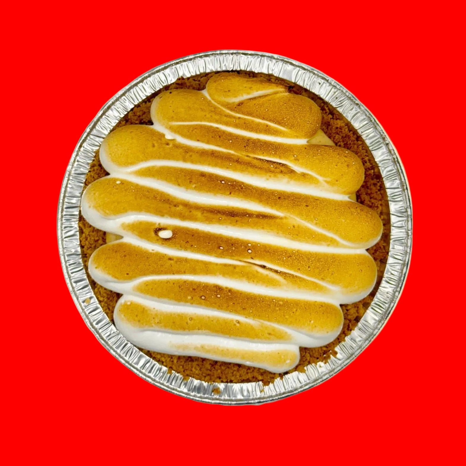 Pumpkin pie with a toasted meringue top on an orange background
